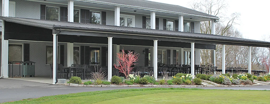 The Pine Hill Golf Course clubhouse beside the putting green.
